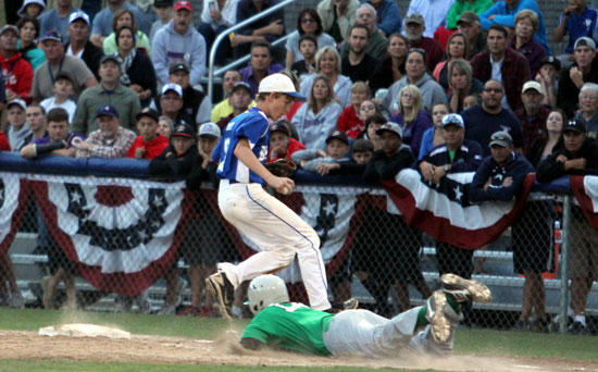 Aaron Orender steps past first base after recording the final out of the 2012 Babe Ruth World Series championship game, beating Greenville, N.C., runner Colin Smith. (Photo courtesy of Teresa Smith, Northwest Sports Photography)