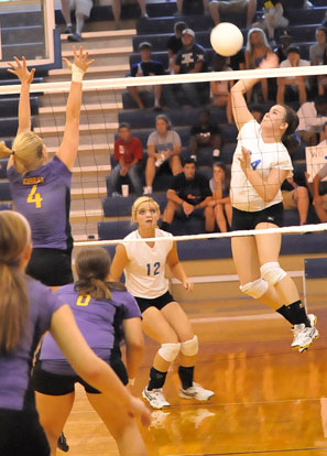 Brooke Howell goes up for a kill in front of teammate McKenzie Rice (12). (Photo by Kevin Nagle)