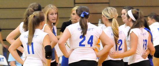Head coach Beth Solomon and assistant Christina Myer huddle with the team during a timeout. (Photo by Kevin Nagle)