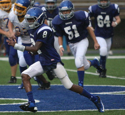 Bryant Blue quarterback Desmond Duckworth turns upfield in front of teammate Kale Kimbroth (51). (Photo by Rick Nation)