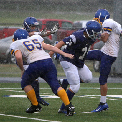 Bryant Blue's London Taylor (74) and Sam Harrison break through to block the punt of Hot Springs Lakeside's Lane Shatley. (Photo by Rick Nation)