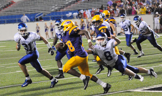 Bryant's Davis Nossaman (8) lunges to tackle Catholic's D.J. Brown as Stoney Stevens (31), Tyree Reese (33), Jake Johnson (35) and Kordell Boykins (65) pursue. (Photo by Kevin Nagle)