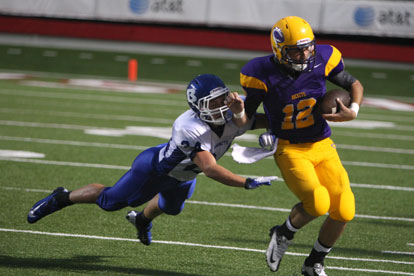 Linebacker Bryce Denker (24) hauls down Catholic quarterback Zac Pinter. (Photo by Rick Nation)