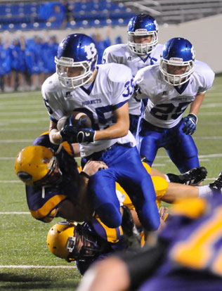 Jake Johnson (35) returns after an interception. (Photo by Kevin Nagle)