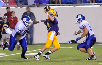 Bryant's Cortez Williams (75) and Tim Kelly (91) put the pressure on Catholic quarterback Zac Pinter. (Photo by Kevin Nagle)