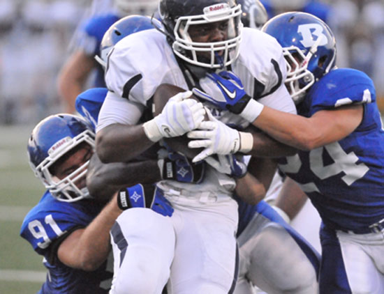 Bryant's Tim Kelly (91) and Bryce Denker (24) latch onto a Conway running back. (Photo by Kevin Nagle)