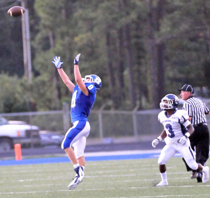 Davis Nossaman (8) leaps up for his interception. (Photo by Kevin Nagle)