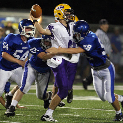 Bryant's Jacob Hall (58), Austin Blacklaw (69) and Walker Brown (54) descent on Catholic quarterback Andre Sale. (Photo by Rick Nation)