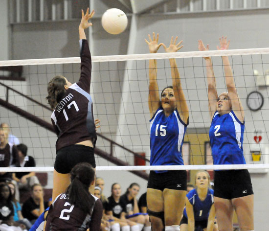 Aubree Allen (15) and Emily Henson (2) go up to try to block an attack. (Photo by Kevin Nagle)