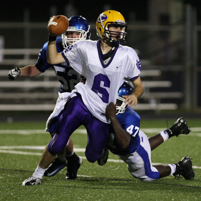 Demaji Price (47) and Blake Robertson (52) get a sack. (Photo by Rick Nation)