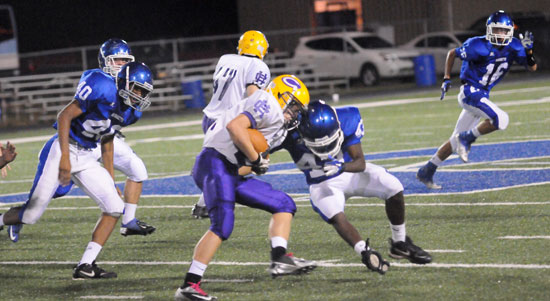 Khaliq Slater (43) makes a tackle as teammates Kameron Guilory (40) and Nick Hardin (16) pursue. (Photo by Kevin Nagle)