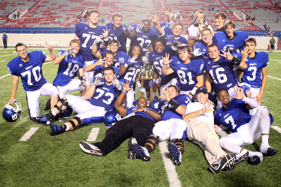 In a now traditional pose, Bryant head coach Paul Calley joins his team's seniors with the Salt Bowl trophy. (Photo by Rick Nation)