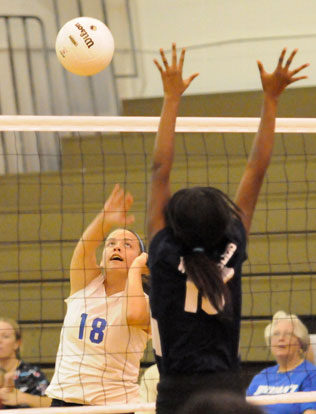 Rylee Phillips (18) sends an attack over the net. (Photo by Kevin Nagle)