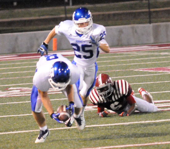 Bryant's Davis Nossaman (8) scoops up a loose ball after teammate Drew Tipton (25) separated it from Pine Bluff's Devarious Rice. Nossaman returned the ball 52 yards for a touchdown on the last play of the first quarter. (Photo by Kevin Nagle)