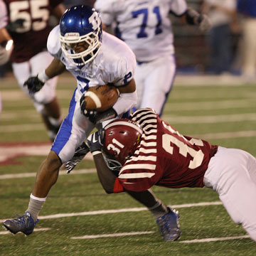 Brushawn Hunter tries to get through a tackle by Pine Bluff's Roderick O'Bryant. (Photo by Rick Nation)