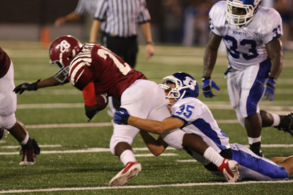 Jake Johnson (35) brings down Trever Hunt (28) for one of his team-high 15 tackles. (Photo by Rick Nation)