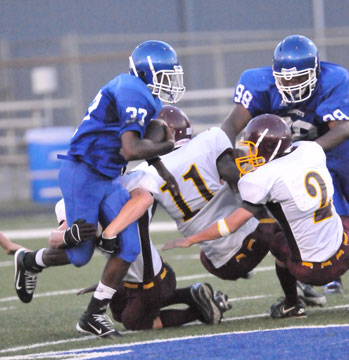 Bryant's Drew Alpe (33) runs through a tackle and gets a block from Cameron Murray (98) as Lake Hamilton's Jason Burks (11) and Jacob Treat (2) try to make the play. (Photo by Kevin Nagle)