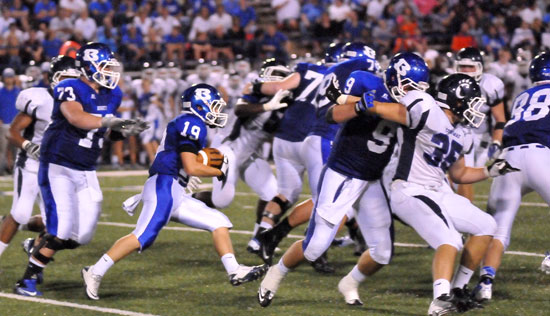 Jacob Irby (19) cuts upfield behind blocking from Blake Hobby (73), Wesley Akers (9), Nate Rutherford (88) and others. (Photo by Kevin Nagle)