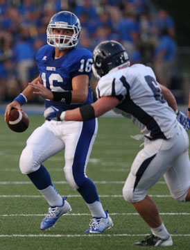 Hayden Lessenberry (16) looks downfield for an open receiver. (Photo by Rick Nation)