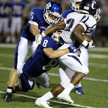 Jake Johnson (35) and Davis Nossaman (8) make a tackle. (Photo by Rick Nation)