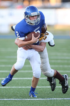 Jake East tries to break a tackle. (Photo by Rick Nation)