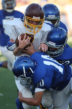 Austin Kelly (10) and a pair of teammates bring down Lake Hamilton's Jacob Graves. (Photo by Rick Nation)