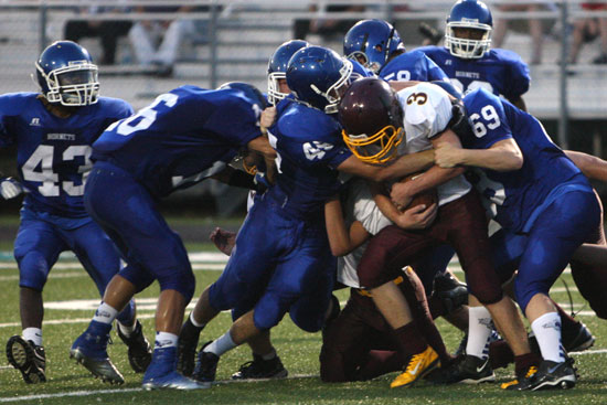 Bryant's Austin Blacklaw (69), Devin Howard (45), Nick Harden (16) and Jacob Hall (58) bring down Lake Hamilton quarterback Dallas Baldwin (3) as Khaliq Slater (43) comes up to help. (Photo by Rick Nation)