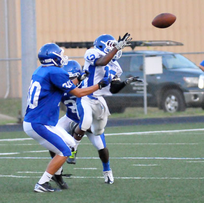 Sophomore Najee Hunt (12) goes up for a pass in front of Dillon Daniels (30). (Photo by Kevin Nagle)
