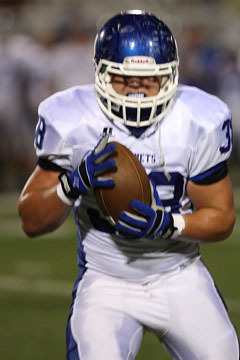 Colton Burton secures his interception on the way to a touchdown return. (Photo by Rick Nation)
