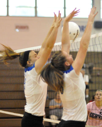 Kendall Selig and Shayla McKissock got up for a block during Thursday's match. (Photo by Kevin Nagle)