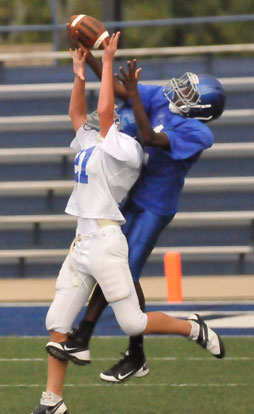 Bryant Blue receiver Randy Thomas, right, battles Bryant White defender Grant Botti (21) for a pass. (Photo by Kevin Nagle)