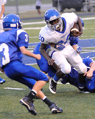 Bryant White's Isiah Ash (20) tries to break a tackle as Bryant Blue's Andrew Darbonne (3) arrives for defensive support. (Photo by Kevin Nagle)