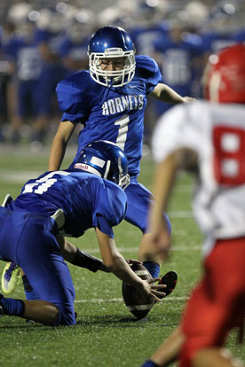 Chase Kincaid (1) boots an extra point out of the hold of Landon Smith (5). (Photo by Rick Nation)