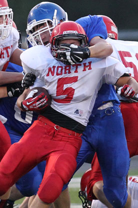 A Bryant defender puts the clamps on Cabot North's Kaleb Schmidt. (Photo by Rick Nation)