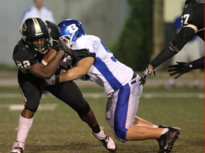 Bryant's Noah Flores, right, makes a tackle. (Photo by Rick Nation)