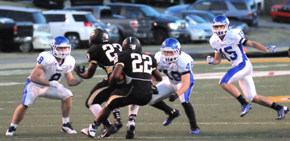 Davis Nossaman (8), Connor Chapdelaine (48) and Ben Bruick (15) hem in Central running back Logan Moragne (22) despite the blocking of fullback Daniel Miller (23). (Photo by Kevin Nagle)