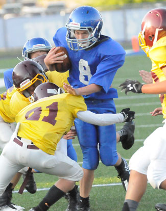 Cody Conrad (8) tries to avoid a Lake Hamilton tackler. (Photo by Kevin Nagle)