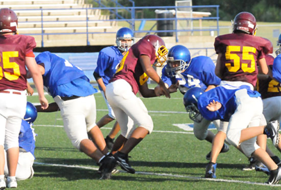 Tyler Jordan (24) takes on a blocker as the Hornets scramble on defense. (Photo by Kevin Nagle)