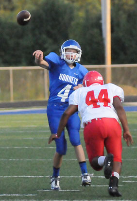 Trey Ashmore gets a throw off before being hit by Little Rock McClellan's D-Shawn Casey. (Photo by Kevin Nagle)