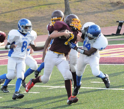 Keshaun Davis (34) grabs Lake Hamilton's Dagen Stacks (7) as help arrives from James Polite. (Photo by Kevin Nagle)