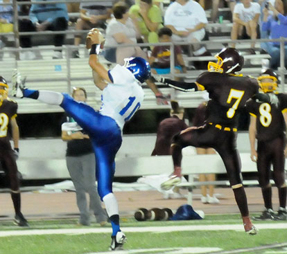 Austin Kelly (10) leaps for an interception in front of Lake Hamilton's Jacob Graves. (PHoto by Kevin Nagle)