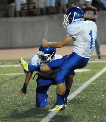 Chase Kincaid (1) kicks an extra point out of the hold of Landon Smith. (Photo by Kevin Nagle)