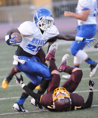 Bryant's Phillip Isom-Green runs over a Lake Hamilton defender. (Photo by Kevin Nagle)