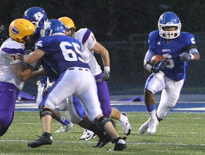 Jacob Ward (65) helps clear the way for Brendan Young (6). (Photo by Rick Nation)