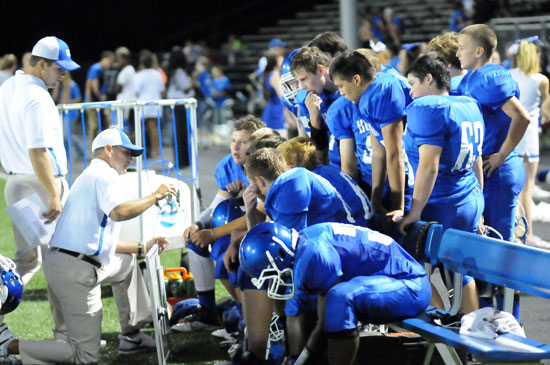 Coaches Travis Queck and Kirk Bock instruct the offense during Thursday's game. (Photo by Kevin Nagle)