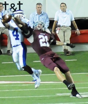 Bryant's Mark Nelson (4) intercepts over Benton's Sam Baker (21). (Photo by Kevin Nagle)