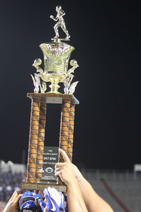 The Hornets hoist the Salt Bowl trophy after their 42-28 victory. (Photo by Rick Nation)