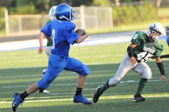 Tyler O'Neal (3) looks for room to get around Pulaski Heights' Kaleb Farrell (45). (Photo by Kevin Nagle)