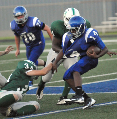 Diante Woodson (14) tries to shake loose of the grasp of Pulaski Heights' Owen White (34). (Photo by Kevin Nagle)