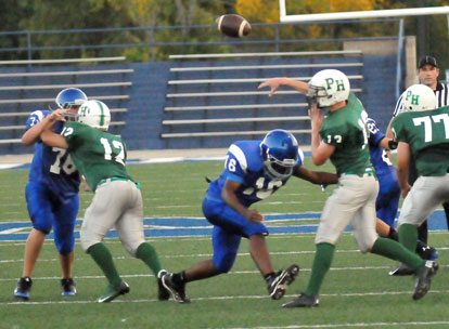 Bryant Blue's Jonathan Smith (16) hits Pulaski Heights quarterback Caleb Dallimore (13) as teammate Joe Wyllia (76) tries to fight through a block by Trey Griffin (12). (Photo by Kevin Nagle)